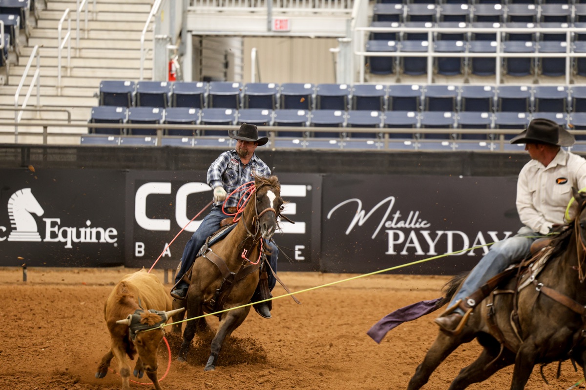 Ryan Motes delivering a heel shot in an indoor arena
