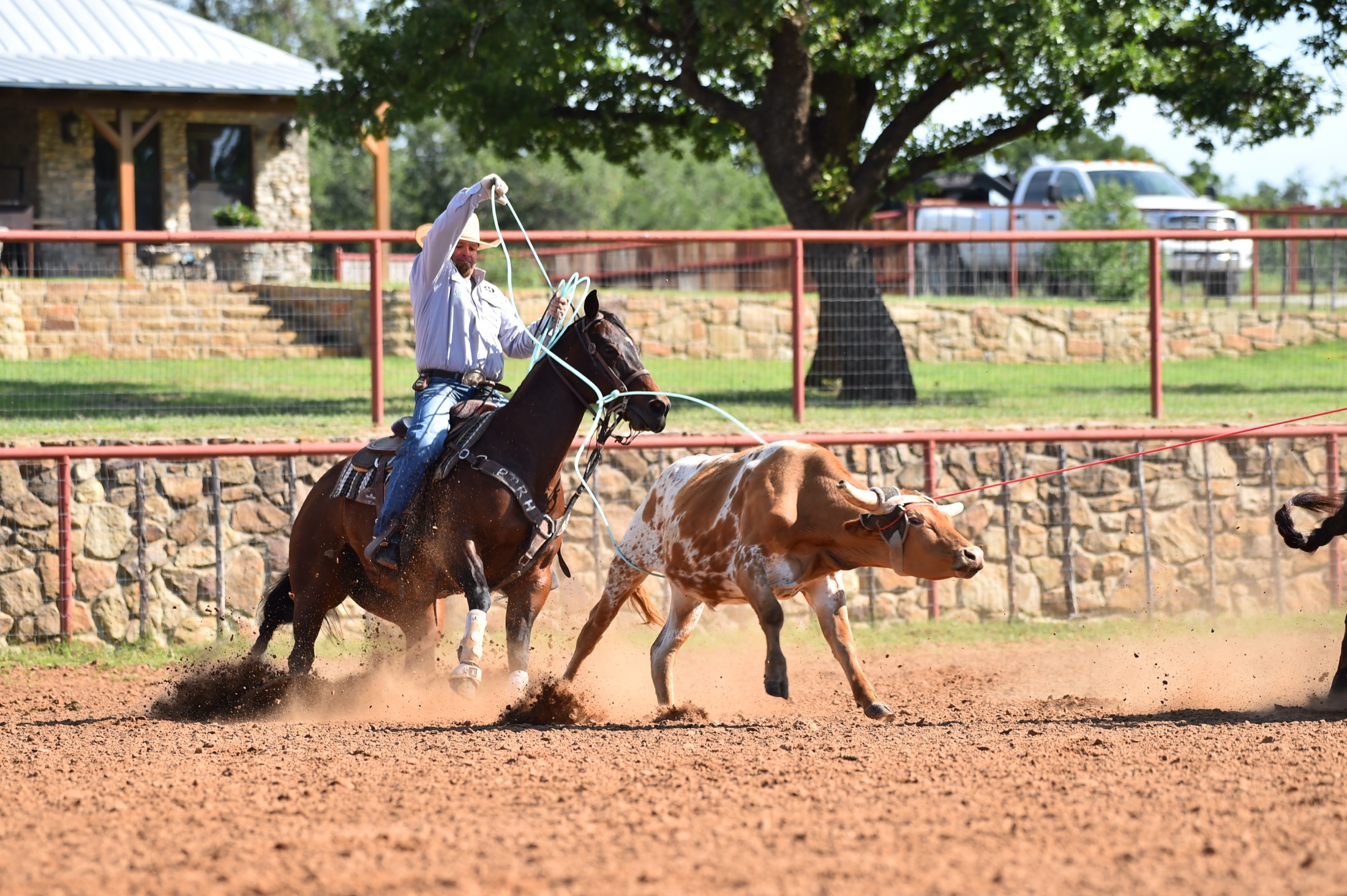 Ryan Motes swinging for a heel shot at a Texas ranch arena